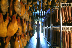 curing room with hanging hams and chorizos