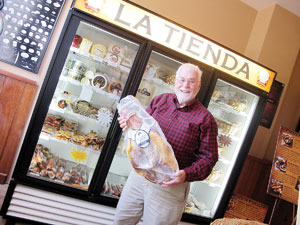Don Harris in the La Tienda store holding a ham