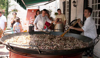 cooking a giant paella on the La Tienda patio