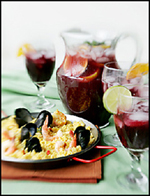 small paella with pitcher and glasses of sangria